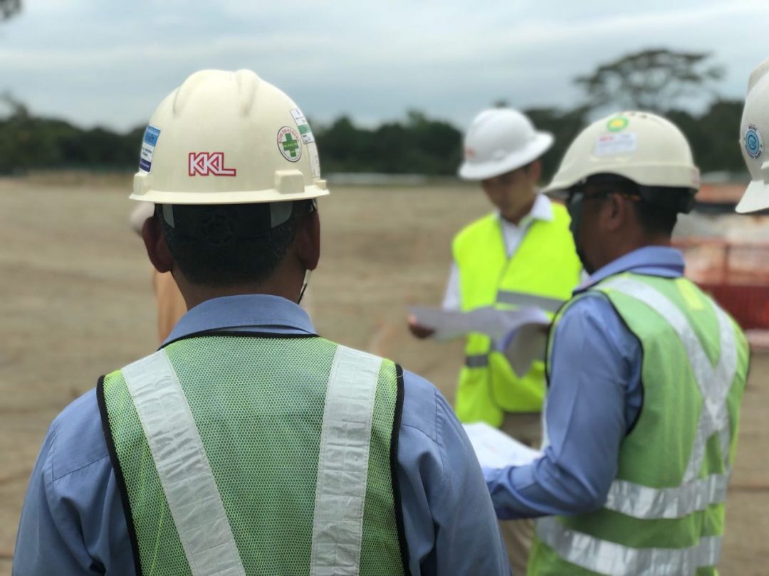 KKL Engineers & Managers Having A Group Discussion On Site